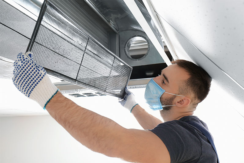 image of technician fixing ac unit